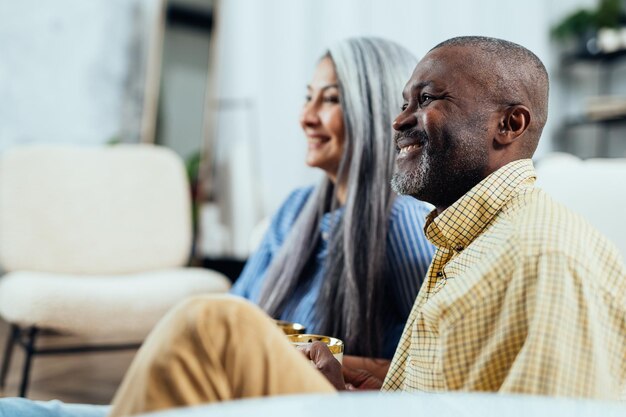 Multiracial senior couple at home