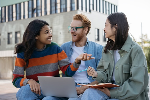 Multiracial smiling students studying together