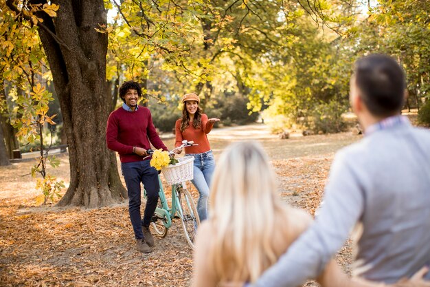 Multiracial young people walking in the autumn park and having fun