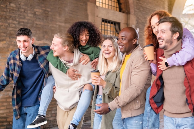 Multiracial young people walking happily on the street Guys and girls having fun together