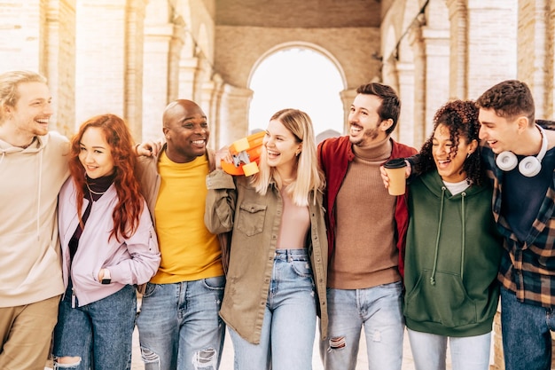 Multiracial young people walking happily on the street Guys and girls having fun together