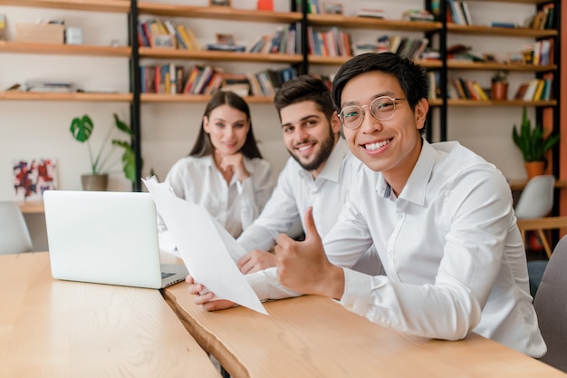 Multiraciale groep zakenlieden die zaken in het bureau bespreken