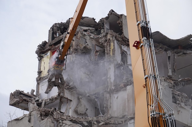 Multistorey building demolished and dismantled by machine