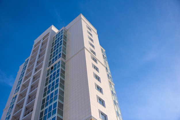 Multistorey residential house on blue sky background