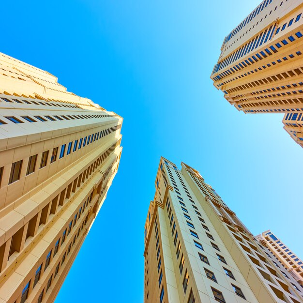 Multistory dwelling buildings against the blue sky, Dubai, UAE.