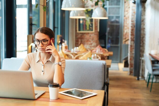 Multitasking lady discussing project with customer