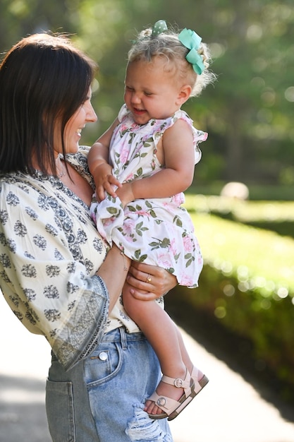 Mum and baby daughter smile and play