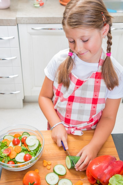 Mum and daughter are cooking together at home