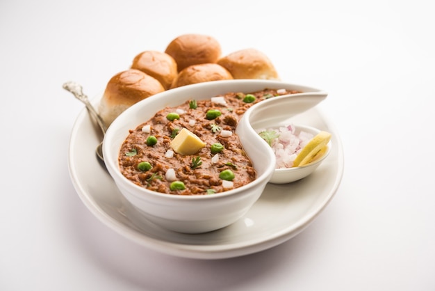 Mumbai Style Pav bhaji is a fast food dish from India, consists of a thick vegetable curry served with a soft bread roll, served in a plate