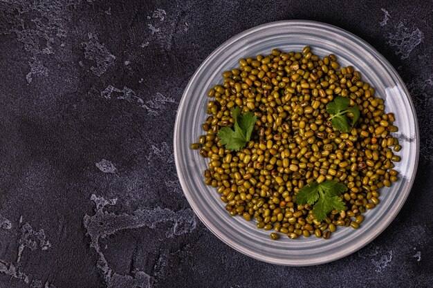 Mung beans with spices on dark background