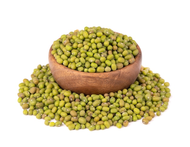 Mung beans in wooden bowl, isolated on white background. Vigna radiata.