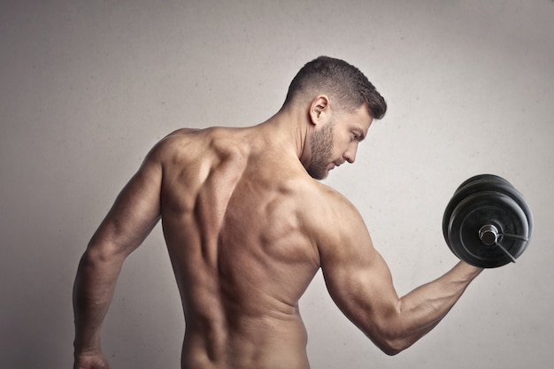 Muscled man lifting weight