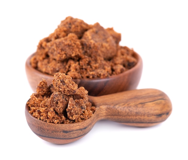 Muscovado sugar in wooden bowl and spoon isolated on white background barbados sugar khandsari or