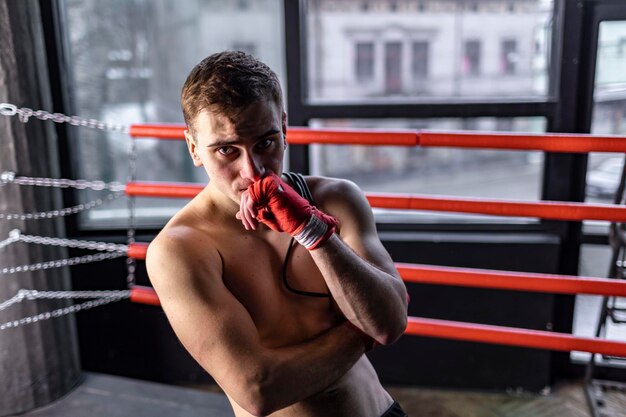 Muscular athlete boxer man with rope in the ring