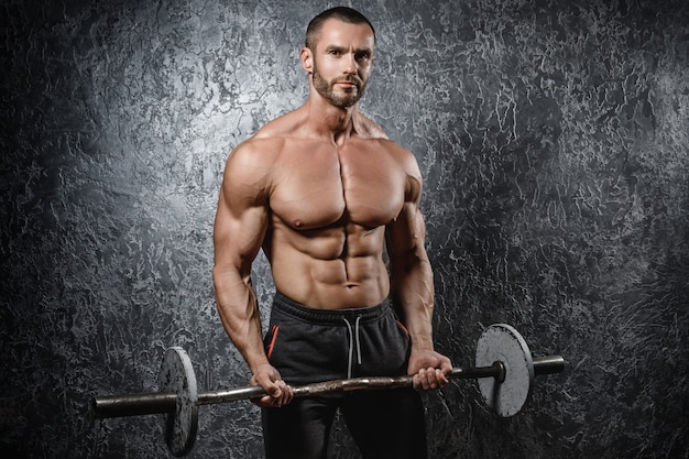 Muscular bodybuilder exercising with a barbell