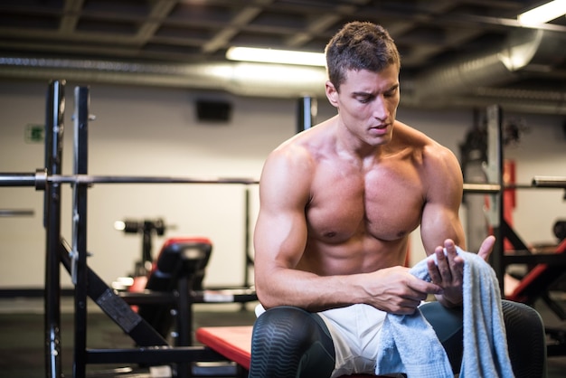 Muscular bodybuilder with towel