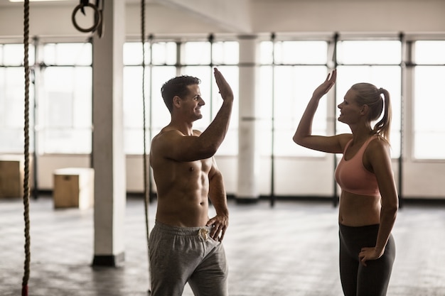 A muscular couple clapping hands