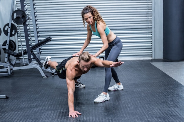 Muscular couple doing abdominal exercises