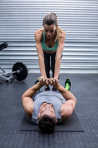 Muscular couple doing core exercises