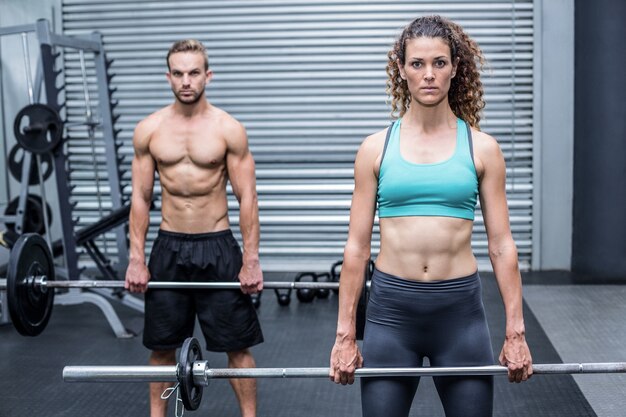 Muscular couple lifting weight together