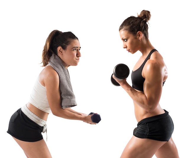 Muscular girl trains with a clumsy girl