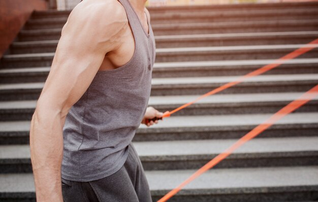 Muscular guy that uses a rope for jumping