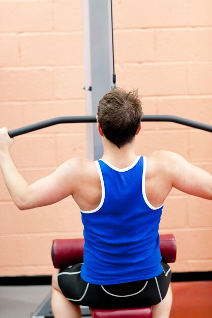 Muscular male athlete practicing body-building