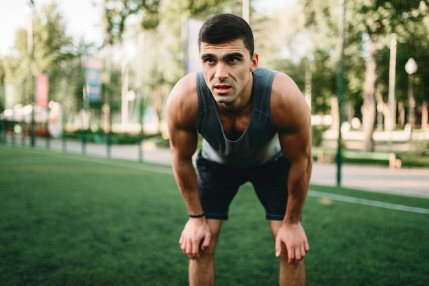 Muscular male athlete prepares for the training