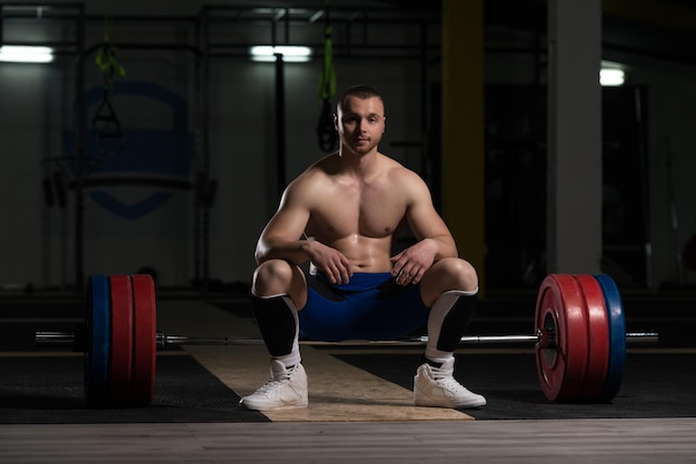 Muscular Man After Exercise Resting In Gym