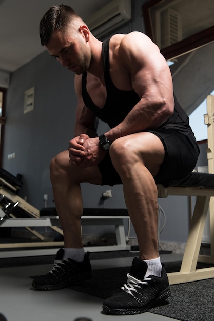 Muscular Man After Exercise Resting In Gym