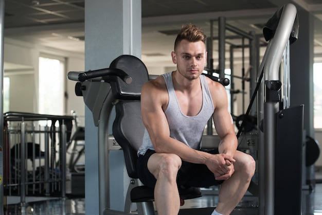 Muscular Man After Exercise Resting In Gym