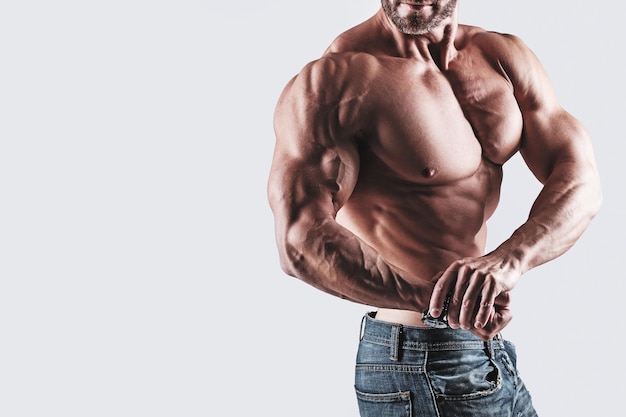 Muscular man bodybuilder wearing jeans