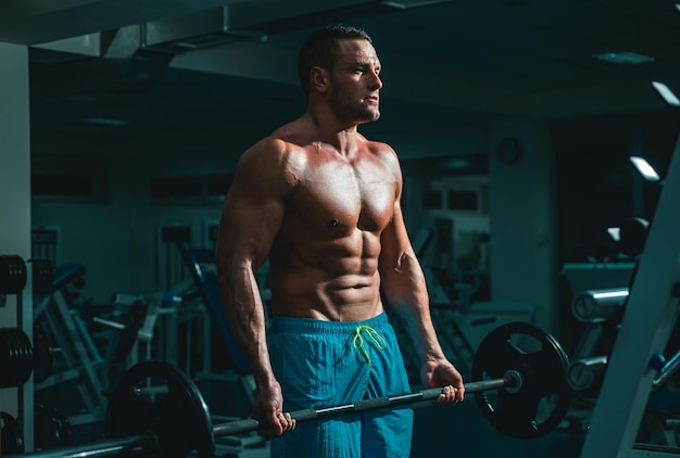 Muscular man doing crossfit young man working out at crossfit gym athletic guy doing exercise