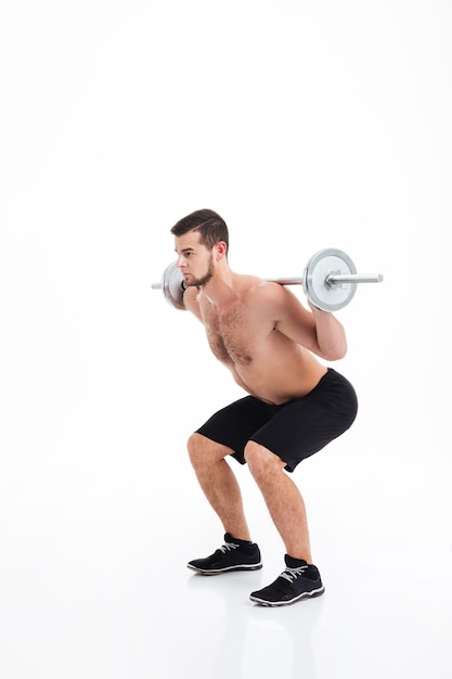 Muscular man doing exercise with barbell