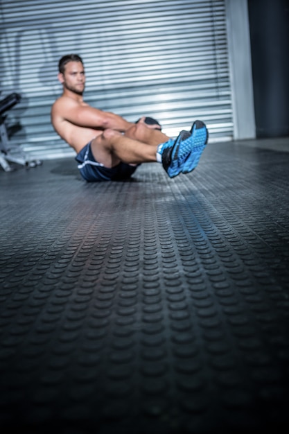 Muscular man doing exercise with medicine ball