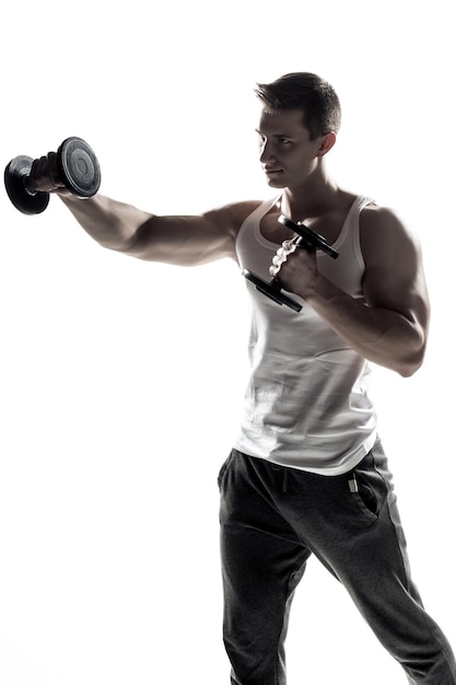 Muscular man doing exercises with dumbbells isolated on white background