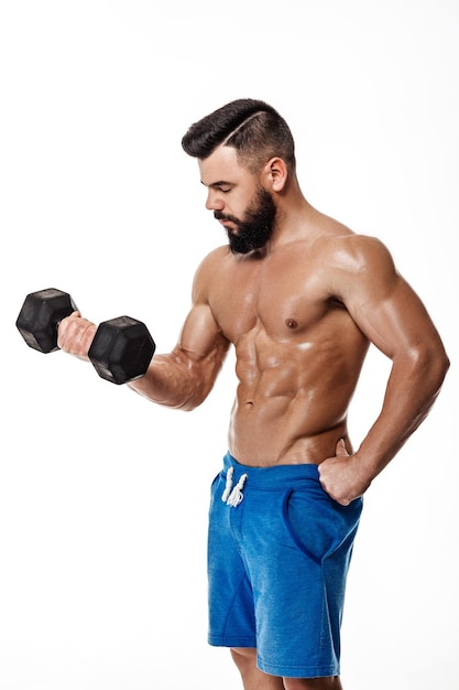 Muscular man doing exercises with dumbbells