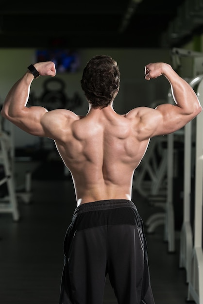 Muscular Man Flexing Muscles Rear Double Biceps Pose