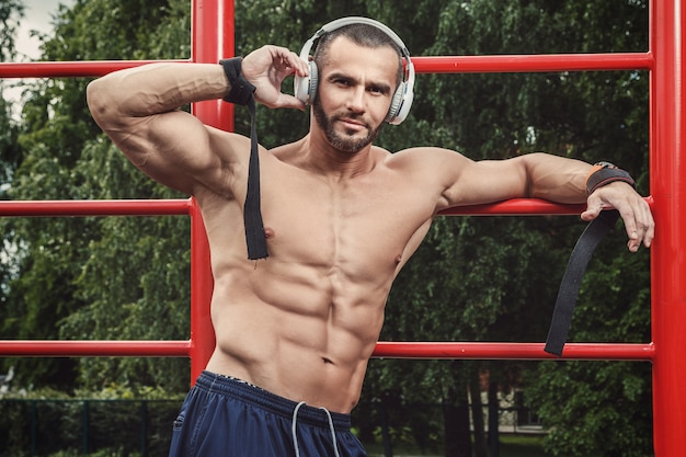 Muscular man listening music