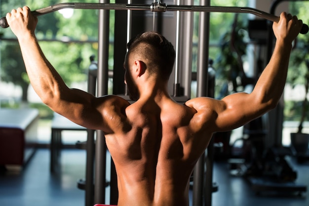 Muscular man training in gym