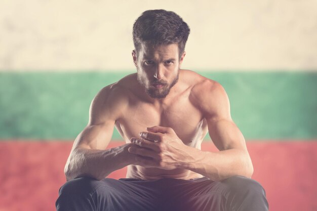 Muscular man with Bulgarian Flag behind