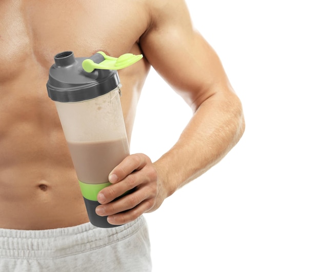 Muscular man with protein shake on white background