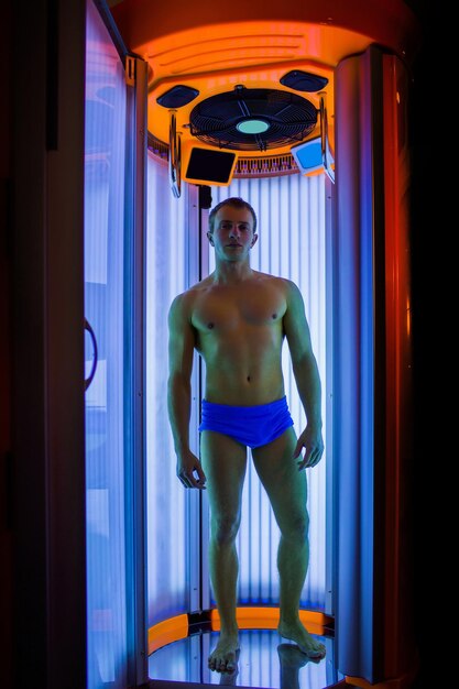 Muscular man with sexy body in solarium