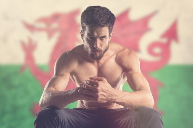 Muscular man with Welsh Flag behind