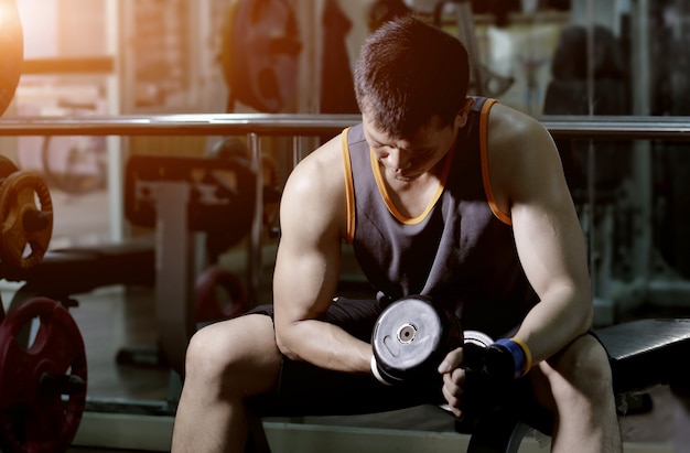 Muscular man working out with dumbbells