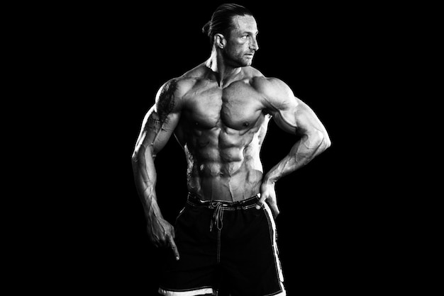 Muscular Mature Man Posing In Studio  Isolated On Black Background