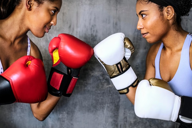 Muscular sportive women ready to box