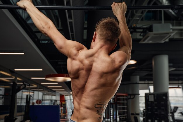 Athlete Doing Pull-up Bar Abdominal Exercise in Gym Stock Photo - Image of  bodybuilder, muscles: 100359300