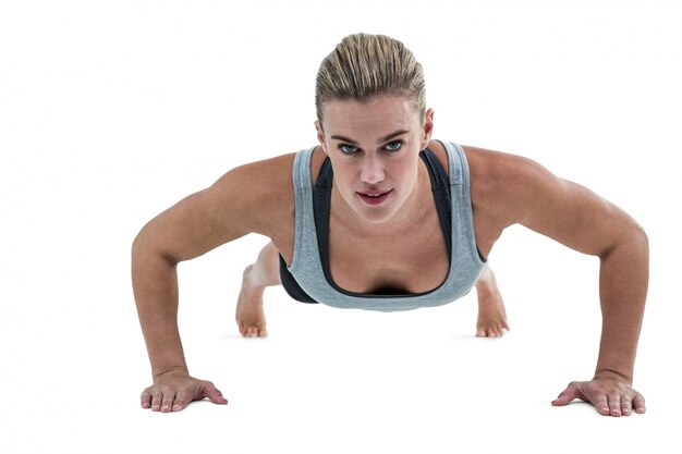 Muscular woman doing push-ups