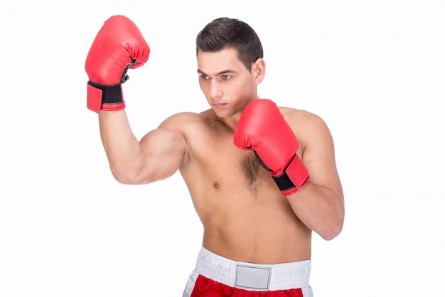 Muscular young man with boxing gloves in sports outfit.